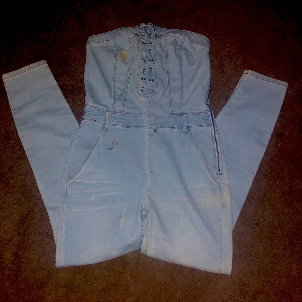 One piece denim jumpsuit lace up front.